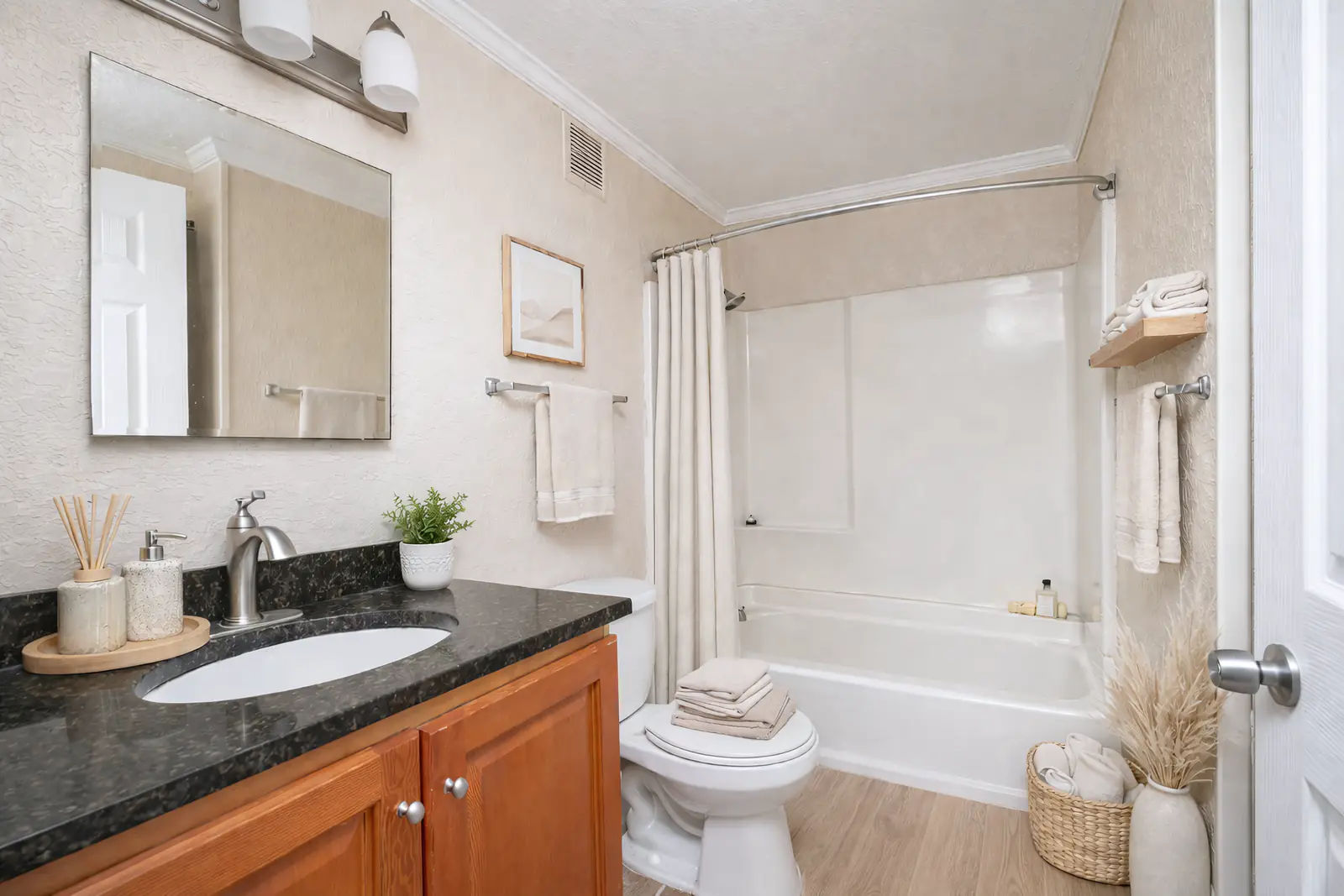 Bathroom with a large vanity and mirror.