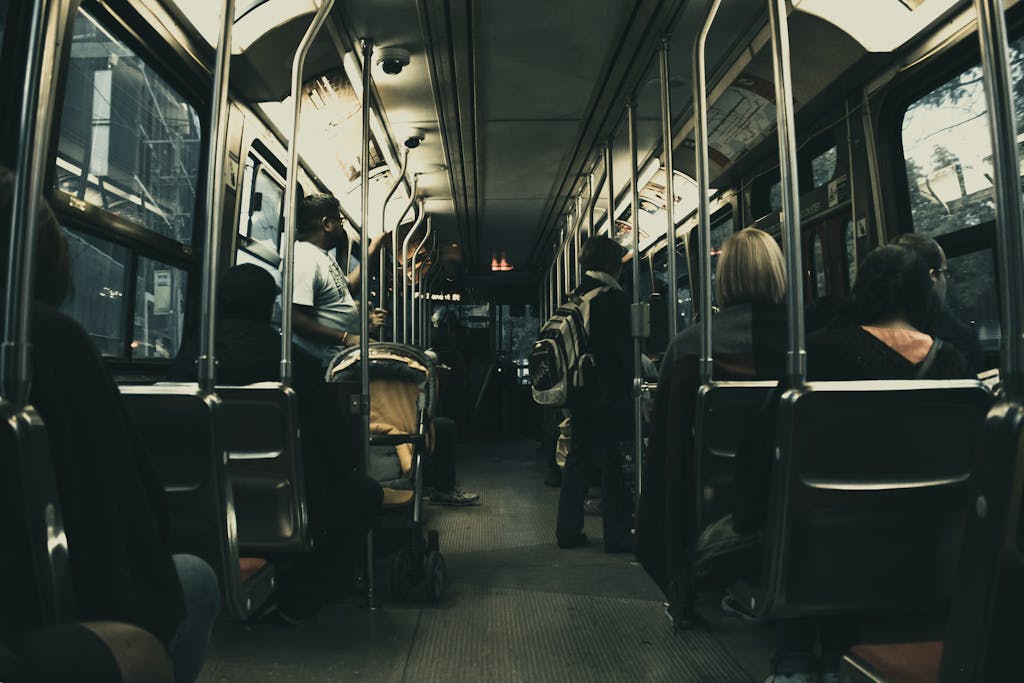 Passengers riding a city bus at night, showcasing urban commute and public transport.