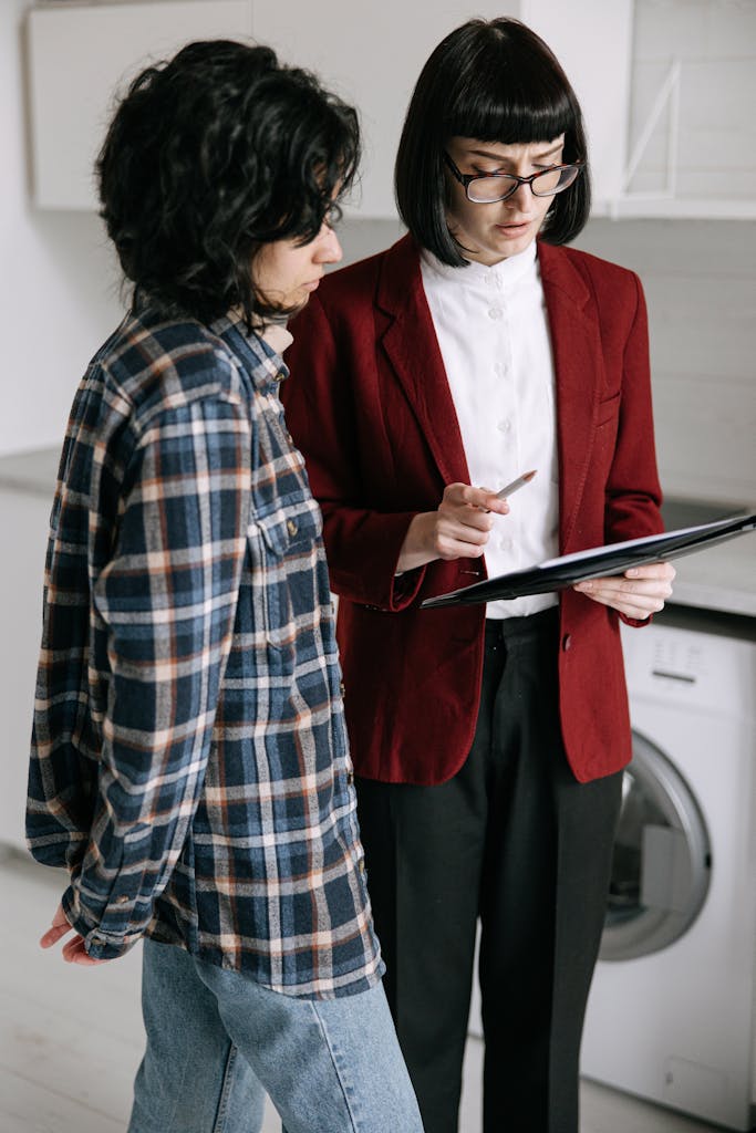 Two women examining a document in a stylish apartment. Perfect for real estate themes.